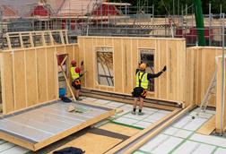 Construction Workers Installing Wall Panel